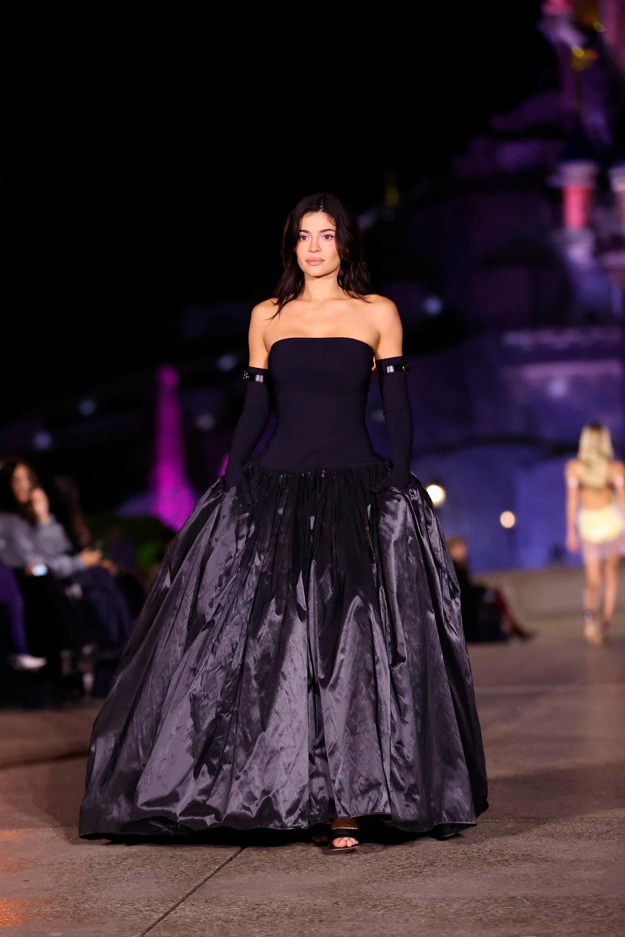 Kylie Jenner en el desfile de Coperni en París. La firma de Alta Costura presentó su colección Primavera/Verano 2025 en un enclave de ensueño, Disneyland París y la 'it girl' cerró el show enfundada en un vestido negro con cuerpo ceñido, escote palabra de honor y falda voluminosa con una fusión de tejidos. 
