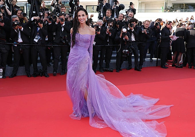 Demi Moore con vestido malva de tela transparente.