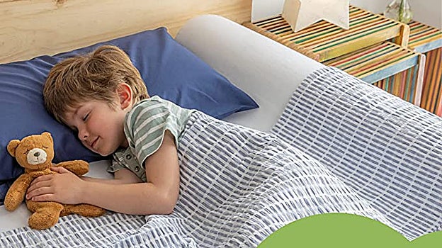 Niño durmiendo en cama con barrera de seguridad