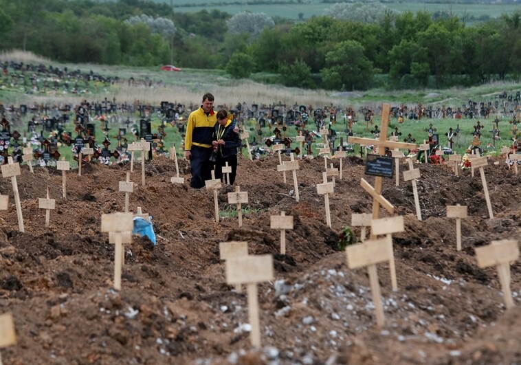 A temporary civilian cemetery on the outskirts of Mariupol
