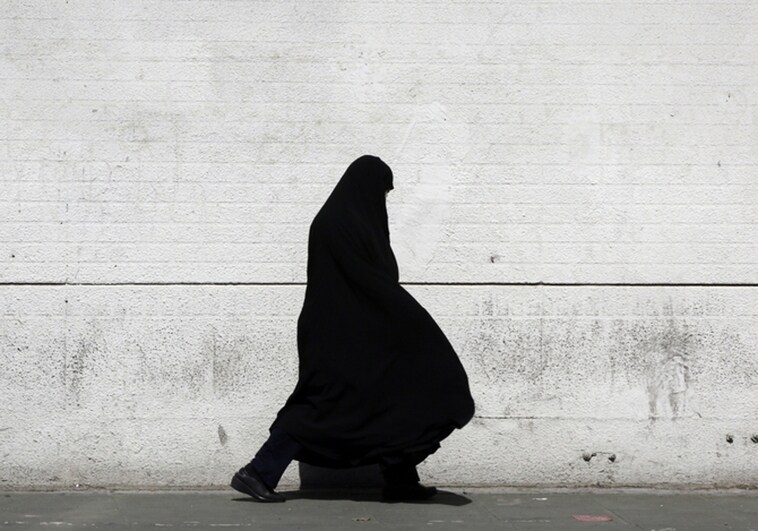 A veiled Iranian woman walks in Tehran
