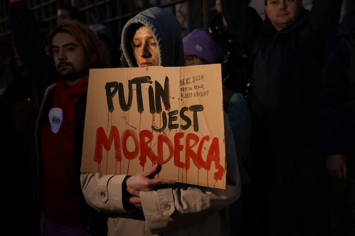 Una mujer en Varsovia sostiene una pancarta que dice «Putin es un asesinoØ