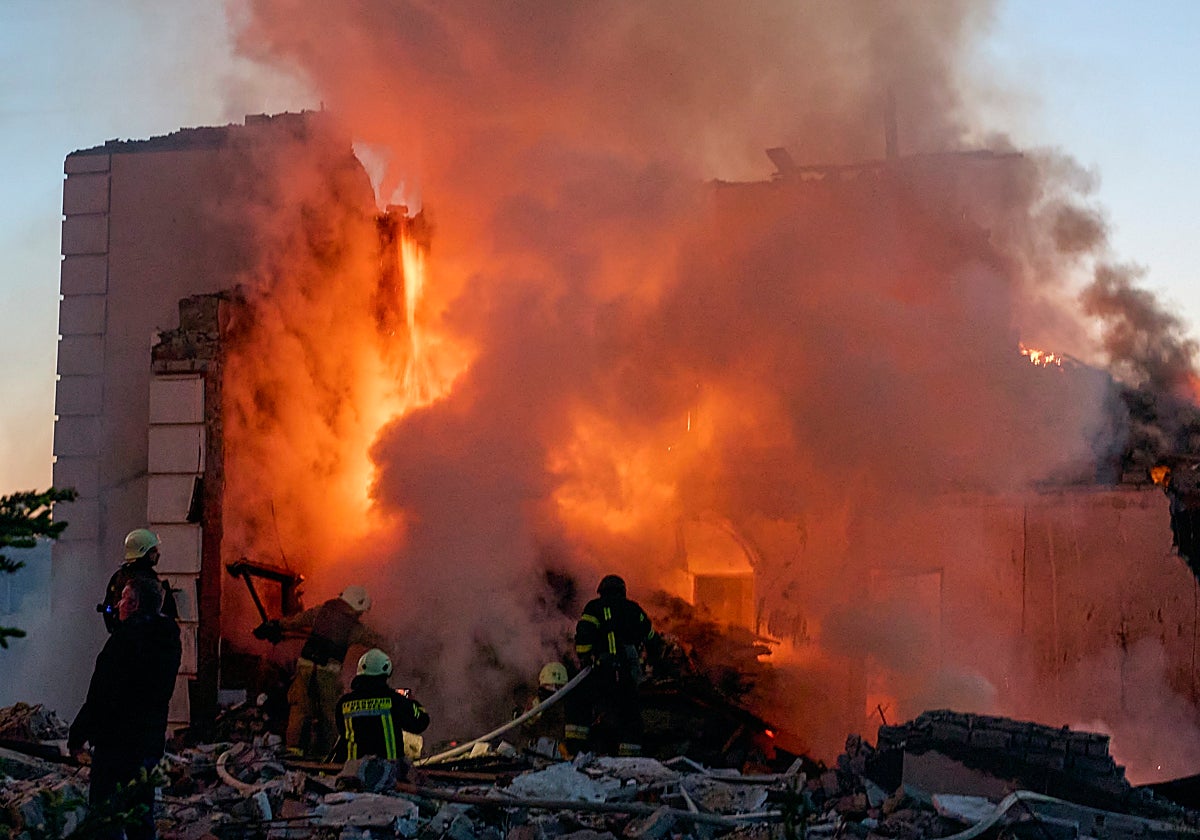 Rescatistas ucranianos trabajan para extinguir un incendio en el lugar de un ataque nocturno con misiles contra edificios privados en Járkov, noreste de Ucrania
