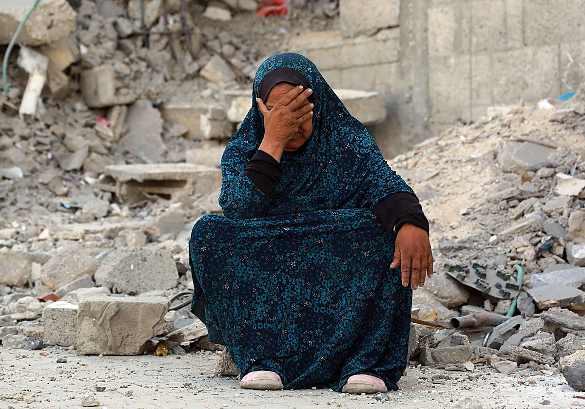Una mujer palestina llora sobre los escombros causados por bombardeos israelíes