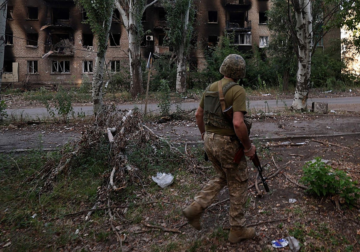Un soldado ucraniano camina por una calle destruida de la localidad de Chásiv Yar