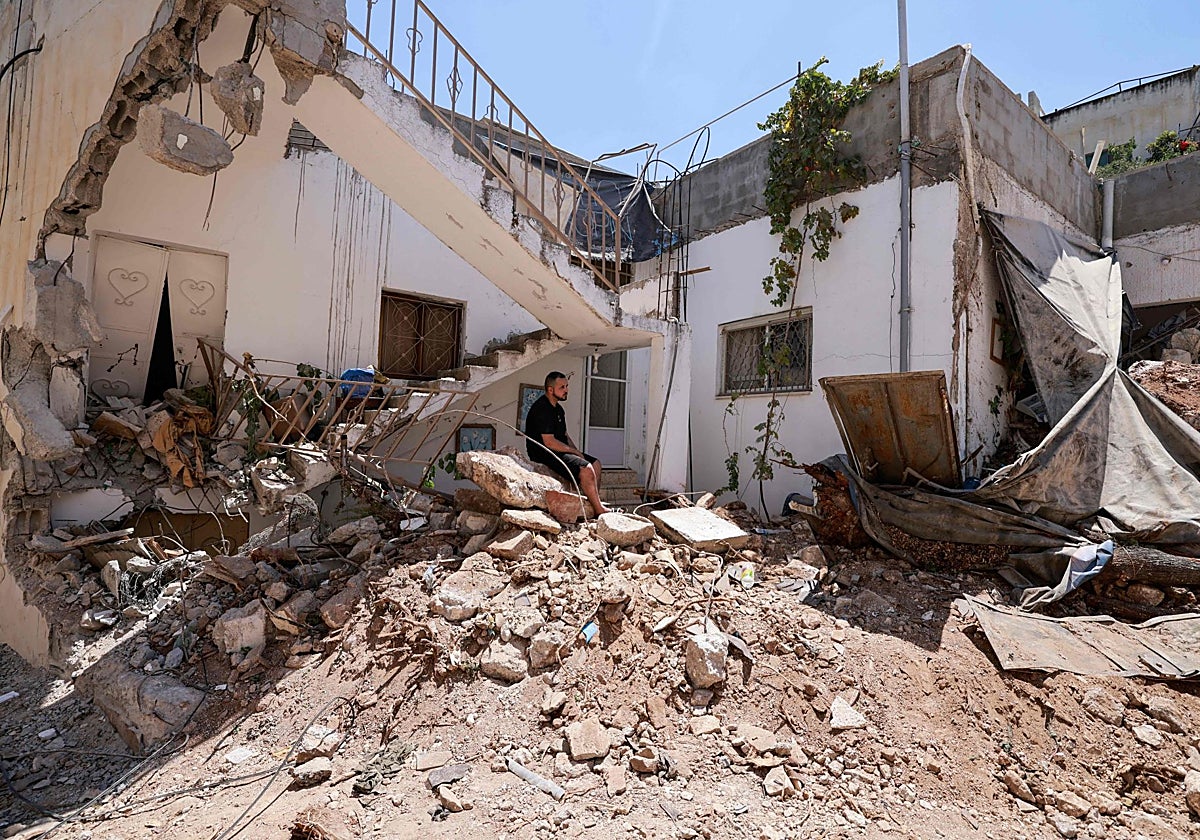 Ciudadanos palestinos investigan la destrucción causada por el ataque israelí