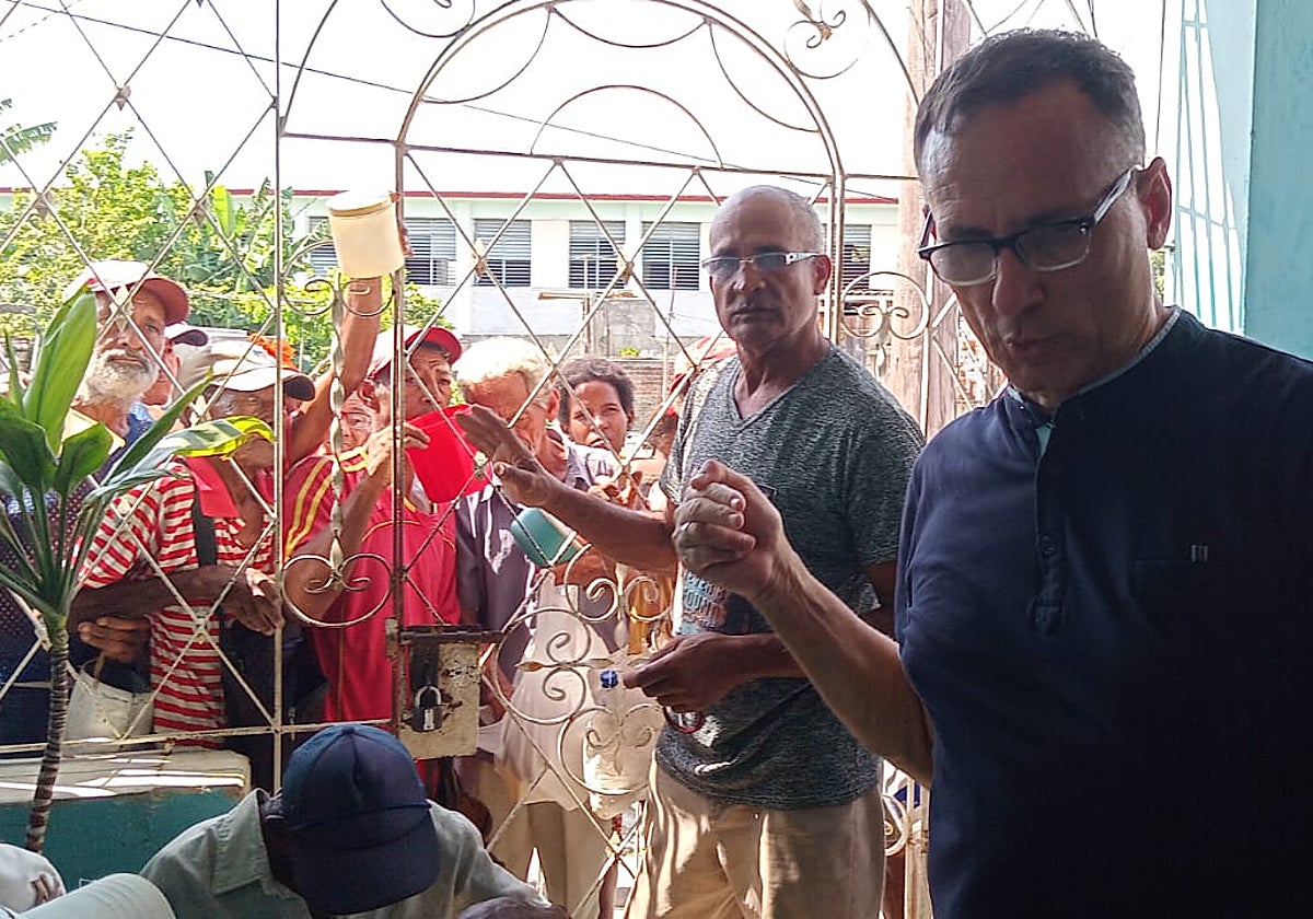 Un grupo de personas esperan en el exterior de la vivienda de José Daniel Ferrer (a la derecha, en primer término) para recibir comida