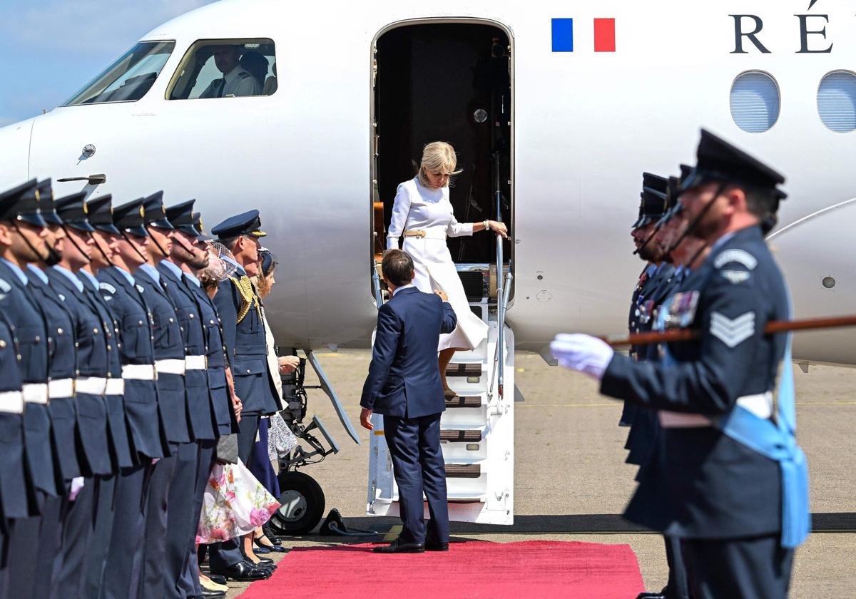 Brigitte y Emmanuel Macron, mientras bajan del avión.