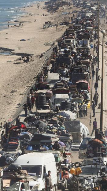 Palestinos desplazados, que huyen del norte de Gaza, se desplazan hacia el sur, en el centro de la Franja