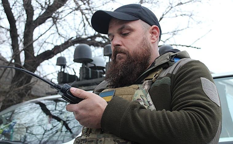 Main image - Sitka, driver of the K-2 brigade, during a trip to the Porkrovsk front; anti-drone networks cover the main routes supplying the front; Igor, a member of the K-2 brigade, observes the sky at one point during the trip