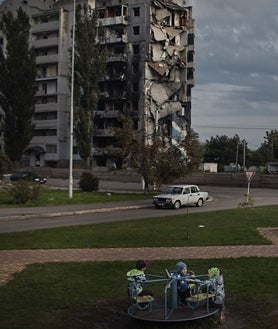 Imagen secundaria 2 - El invierno demográfico que vive Ucrania se traduce una infancia solitaria, como la de Myroslava, de siete años, quien se quedó sin baile de fin de curso por la guerra (primera imagen), o entre escombros, como la de Misha, de nueve años, en su casa de Chernihiv (segunda imagen). En Ucrania, los niños juegan en los parques bajo las ruinas de los edificios bombardeados (tercera imagen) 