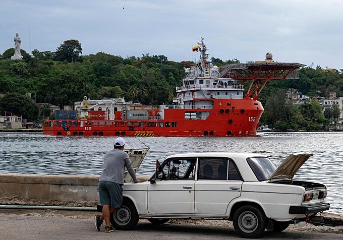 Un hombre revisa su viejo Lada de la época soviética mientras el buque ARC Caribe de la Armada colombiana llega a La Habana con ayuda humanitaria