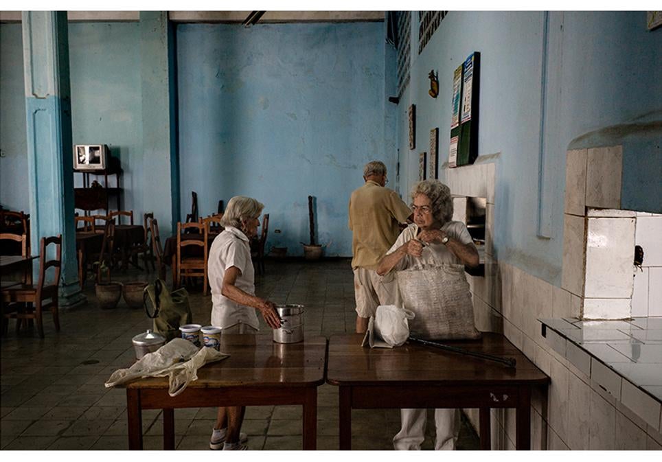 Reparto de comida dentro de un comedor social en La Habana Vieja.