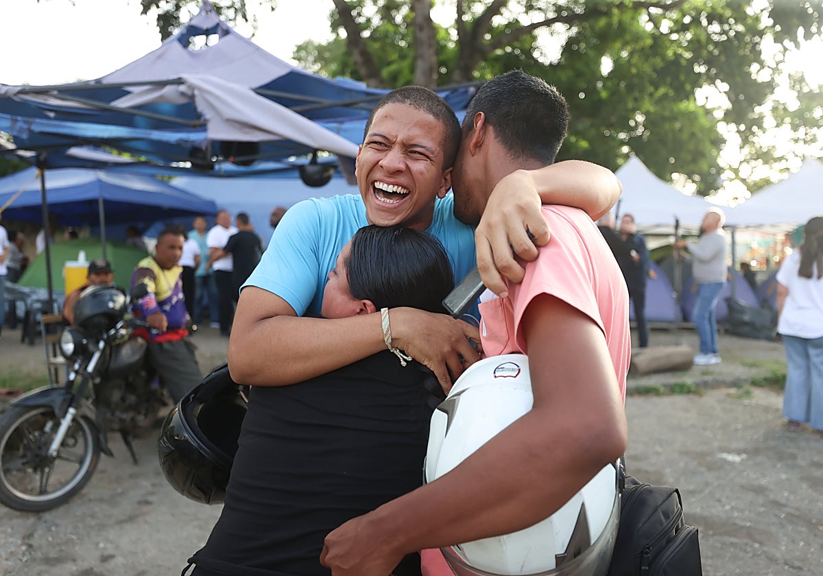 Leomar Guerra (c) abraza a sus familiares tras ser excarcelado del centro penitenciario Rodeo 1