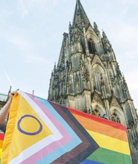 Imagen secundaria 2 - Arriba, una mujer, revestida con un alba, imparte la bendición a una pareja de mujeres. Debajo, en la concentración también han participado grupos de extrema izquierda que recriminaban a los gays su cercanía a la Iglesia católica. A la derecha, la plaza frente a la catedral se ha llenado de simbología del colectivo LGTBI.