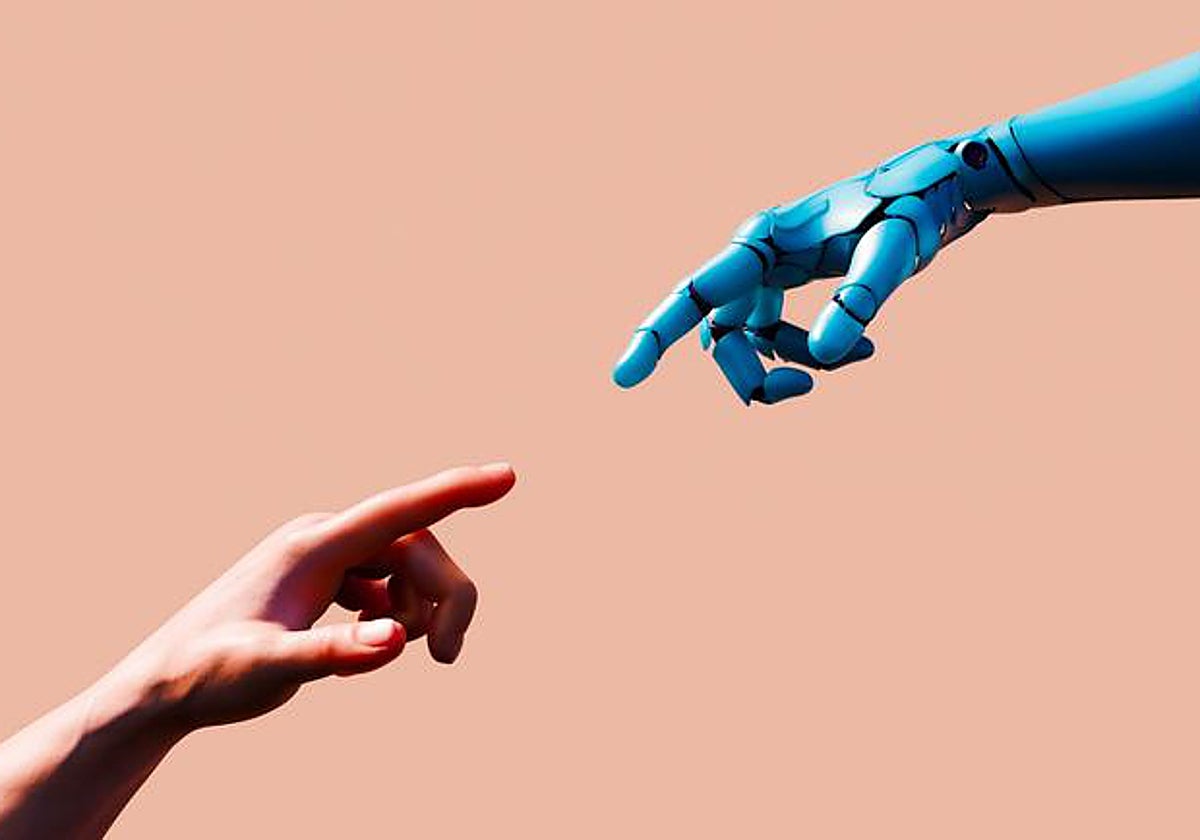 Una mano humana y una extremidad robótica