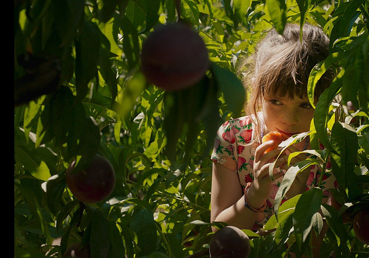 La pequeña protagonista de 'Alcarràs', con uno de los melocotones del pueblo