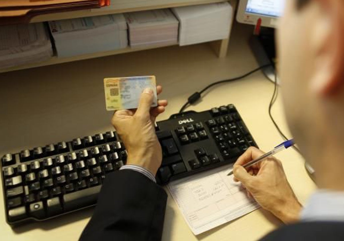 Un funcionario revisando el nombre y apellidos de un ciudadano