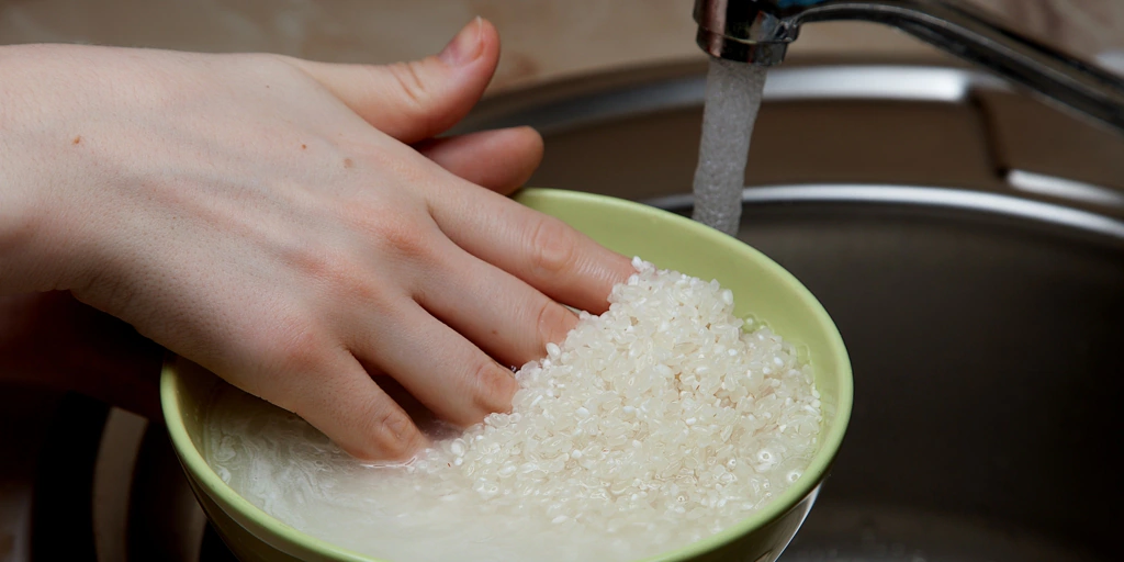 Is it necessary to wash the rice before cooking it?