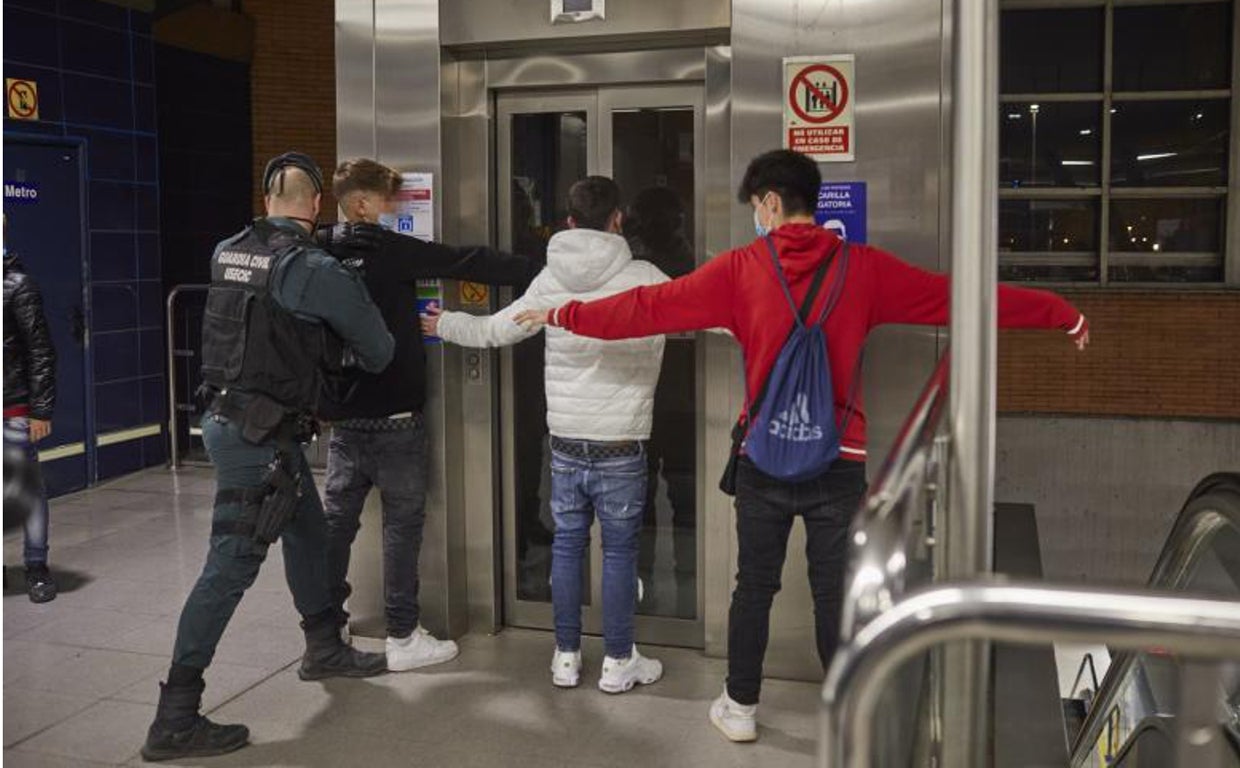 Un guardia civil cachea a unos menores