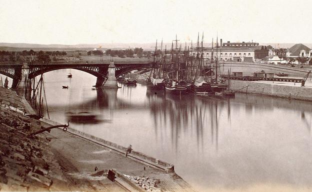 Veleros atracados junto al puente de Isabel II y calle Betis en construcción, entre 1868 y 1872