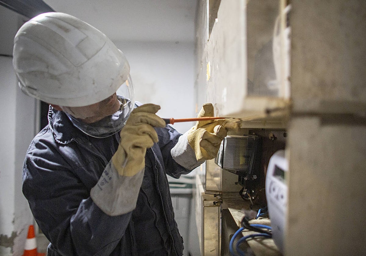 Un técnico de Endesa trabaja para desconectar un enganche ilegal en un suministro de Torreblanca