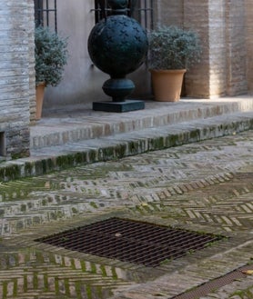 Imagen secundaria 2 - La boca de uno de los aljibes, la cripta que da acceso a la galería almohade y una arqueta de la misma en el patio de los naranjos