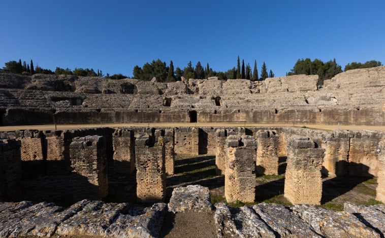Imagen principal - Arriba, el anfiteatro, que albergaba los juegos gladiatorios. Abajo a la izquierda, hornacina en la que estaría representado el principal dios de Itálica. Hay hipótesis que señalan que podría haber albergado una estatua de Adriano. Abajo a la derecha, bronce jurídico con una ley dictada por Marco Aurelio.