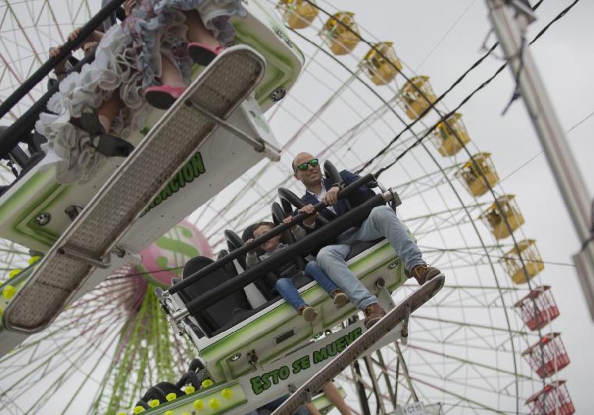 Un padre junto a su hijo en una de las atracciones de la Calle del Infierno