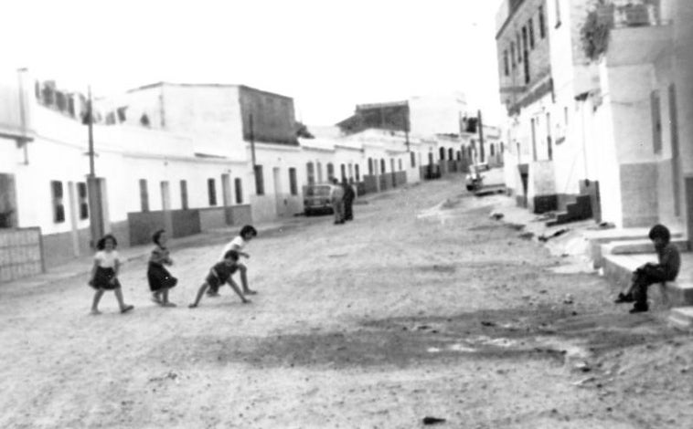 Imagen principal - Arriba, calles sin acerado de Bellavista en el año 1977; abajo, a la izquierda, escrito del que queda constancia del deseo vecinal de construir una escuela, cosa que se conseguiría cinco años más tarde; a la derecha, acta de constitución de la asociación de vecinos en 1976