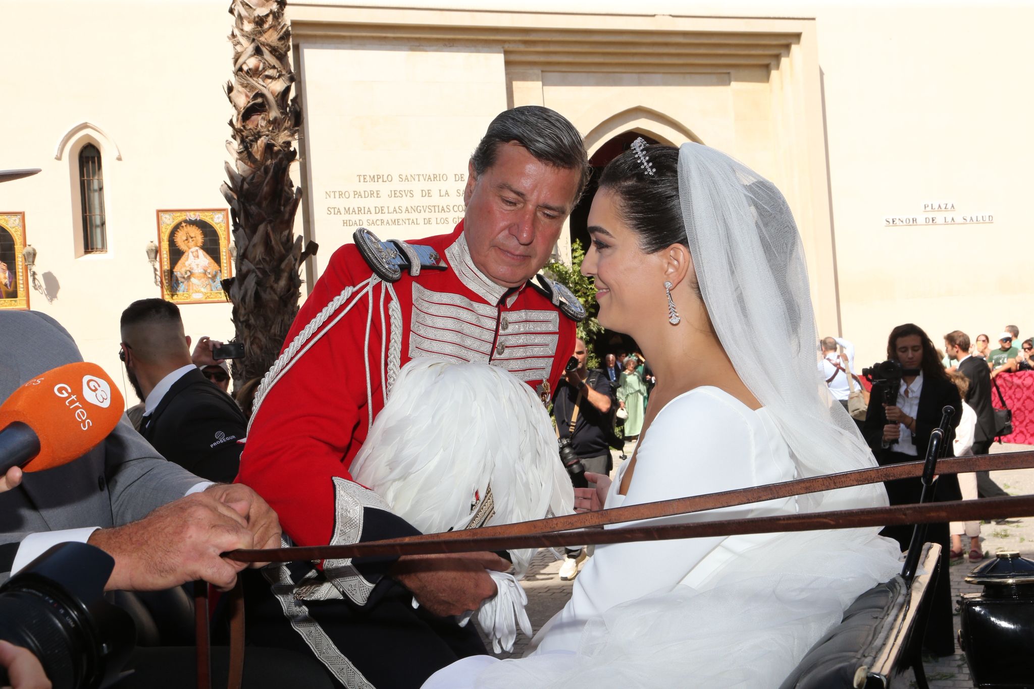Los novios sentados en el coche de caballos