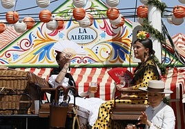 Un coche de caballos parado delante de una de las casetas de la Feria de Sevilla