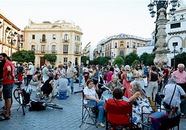Cientos de sevillanos sentados en la plaza Virgen de los Reyes este jueves