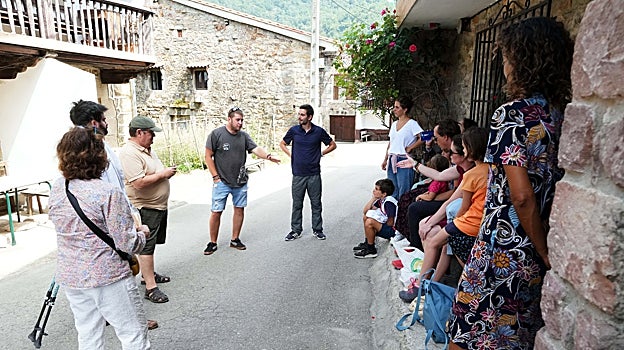 Un joven explica el 'misterio' de Garabandal a varios fieles que han acudido a la aldea