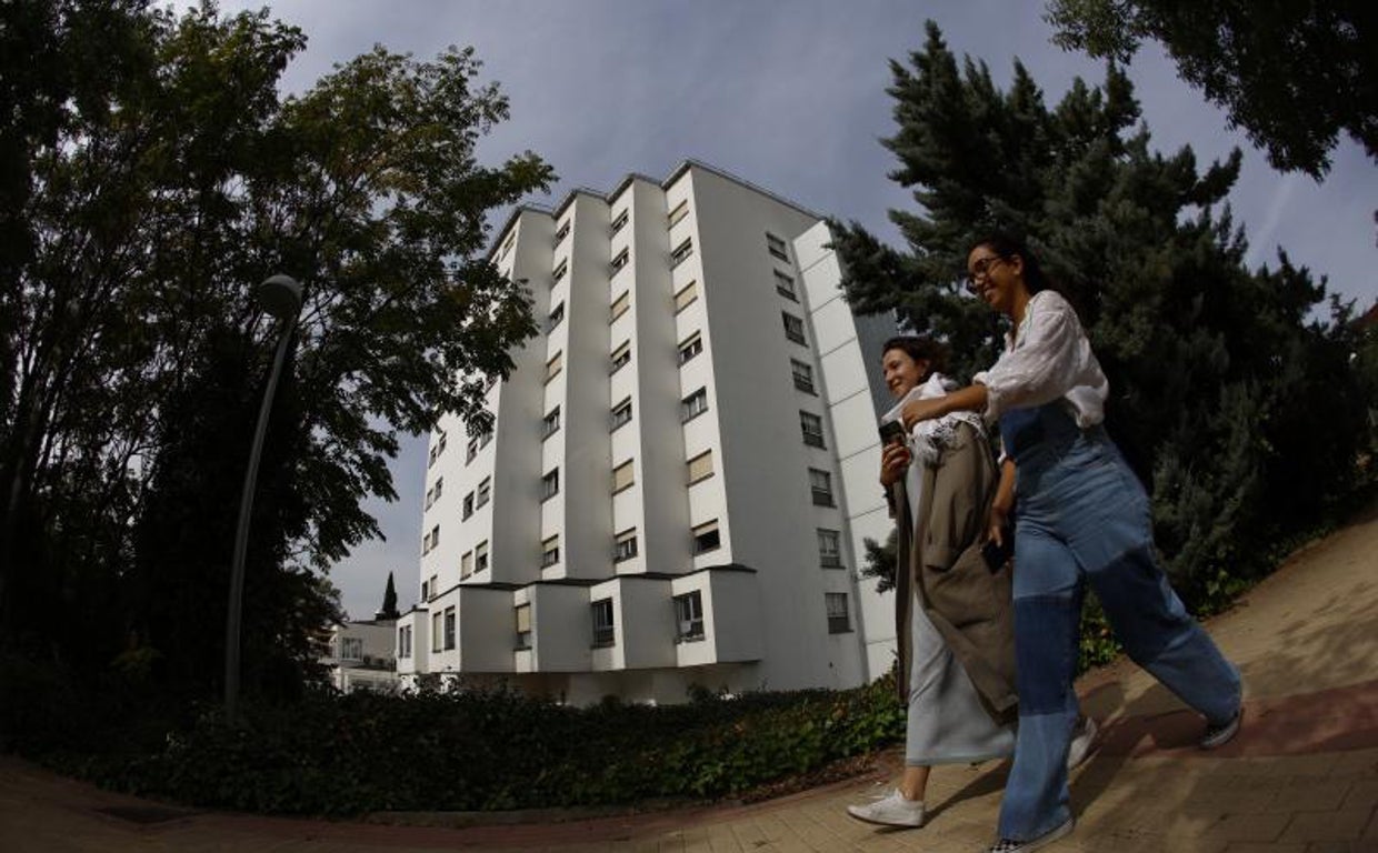 Dos jóvenes pasan frente al colegio mayor Elías Ahuja