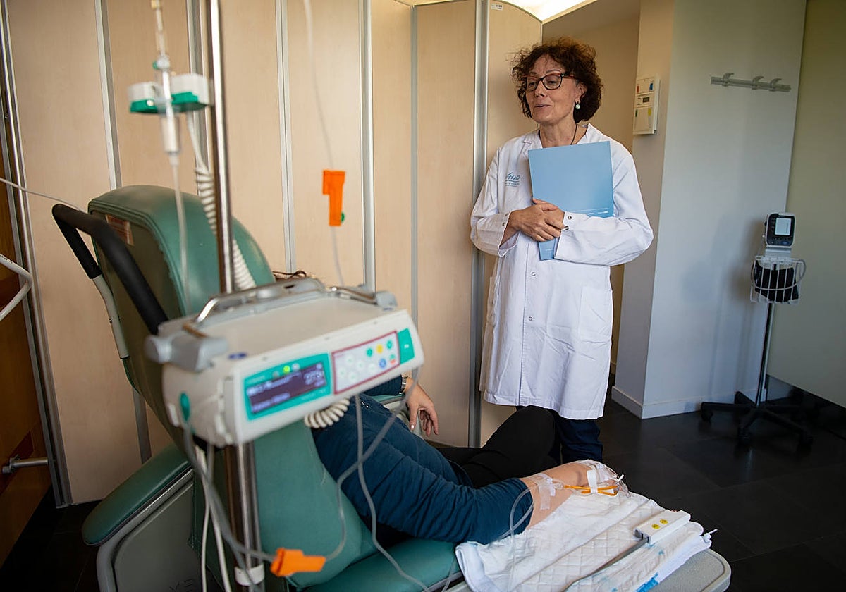 Una doctora atiende a un paciente durante una sesión de quimioterapia en el hospital del Vall d'Hebron