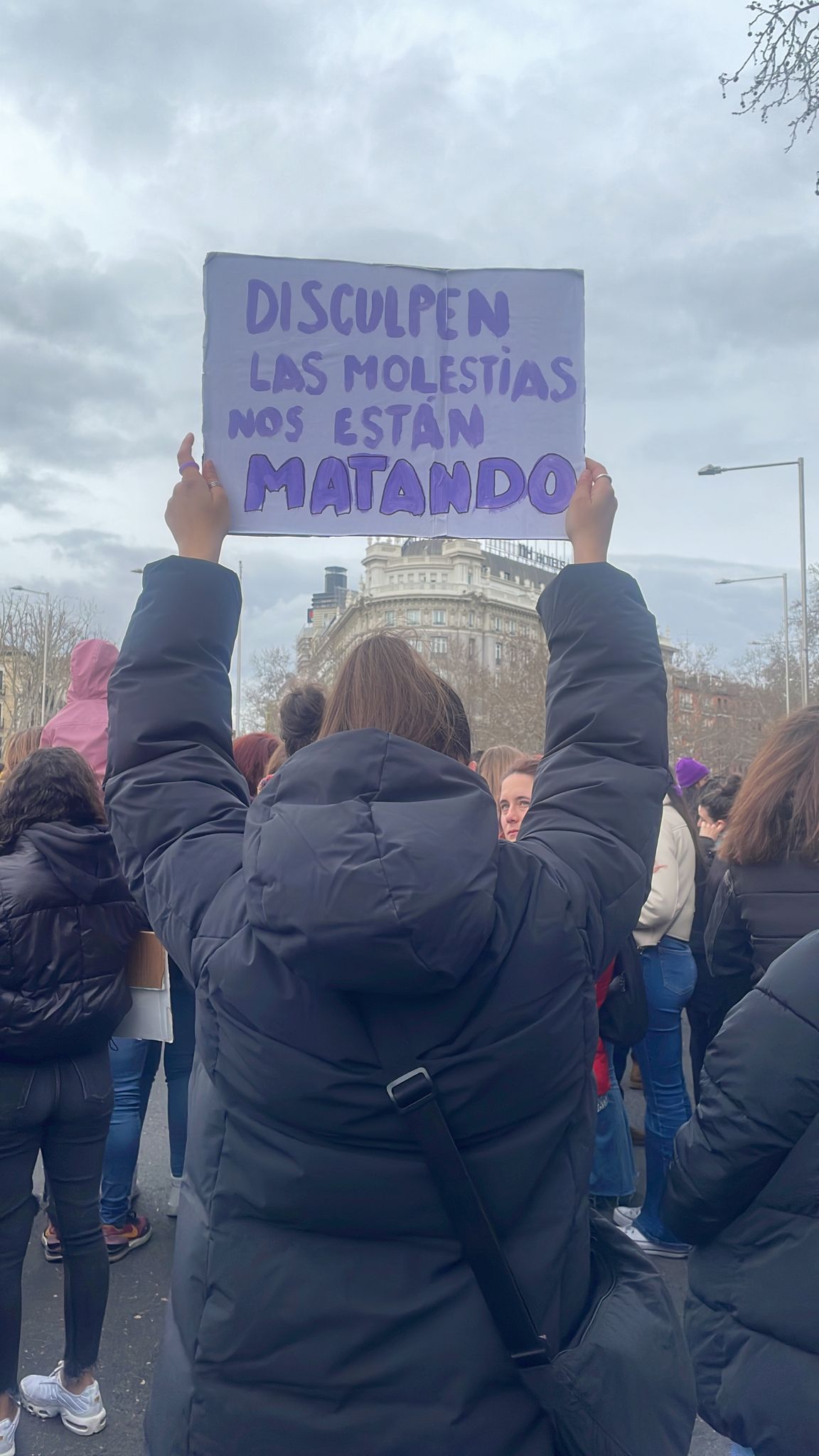 Una joven sujeta una pancarta antes del inicio de la manifestación de la Comisión 8M