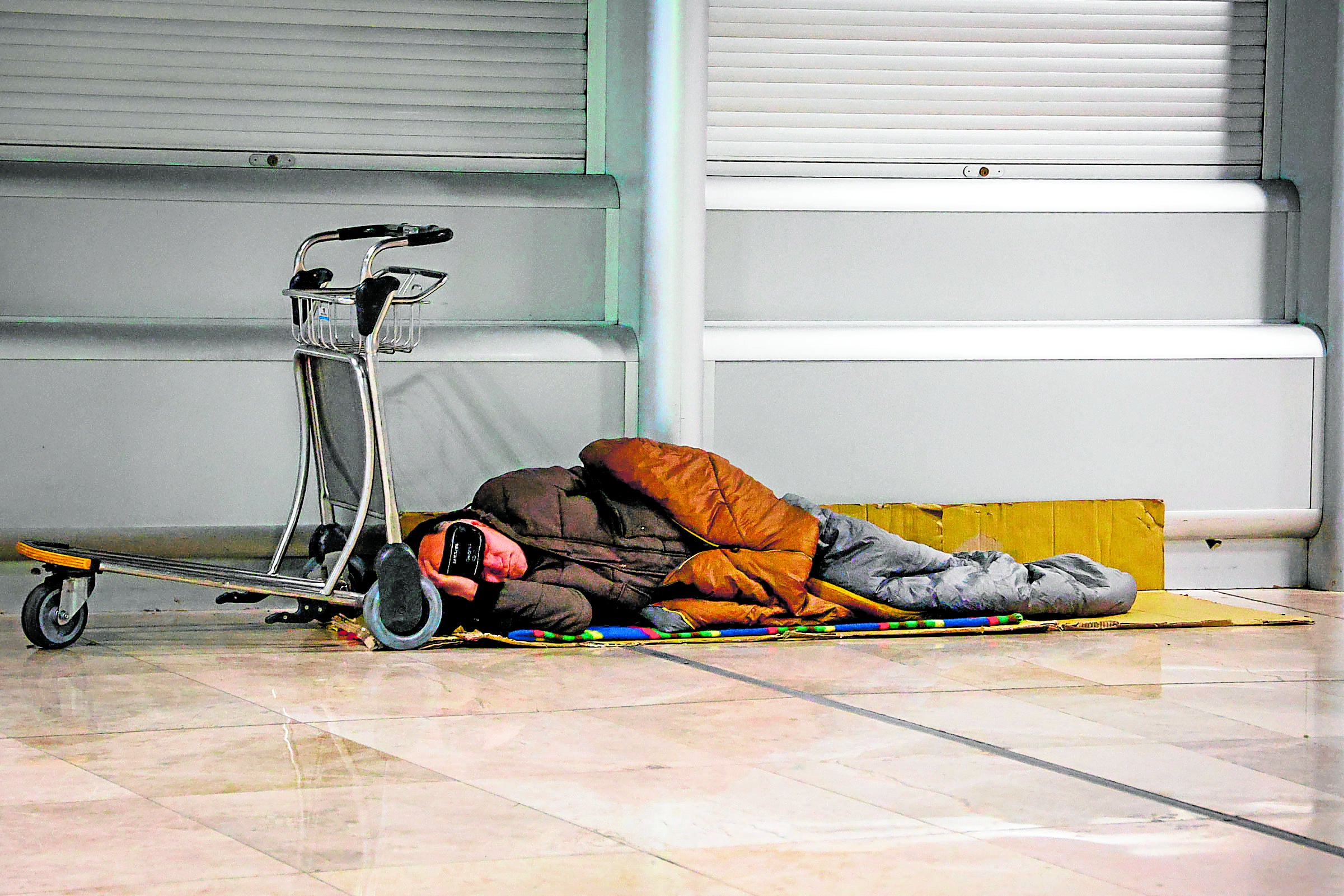 Imagen secundaria 2 - Paz no quiere revelar su nombre porque nadie sabe dónde está. Unas 300 personas sin un hogar, como el rumano Florie, de 56 años, viven bajo este techo de la capital