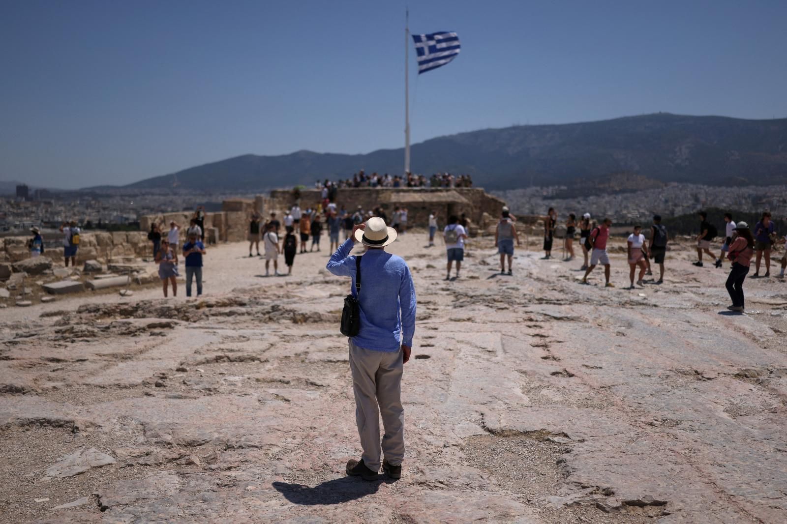 Un turista visita la colina de la Acrópolis durante la ola de calor en Atenas, Grecia.