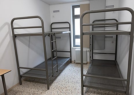 Imagen secundaria 1 - Arriba, el torno que da acceso a las habitaciones del centro abierto de la Zona Franca. Sobre estas líneas, una de las habitaciones, con dos literas, construidas por los propios presos, y la vista de uno de los patios interiores, al que dan los cuartos. Las ventanas no tienen rejas. 