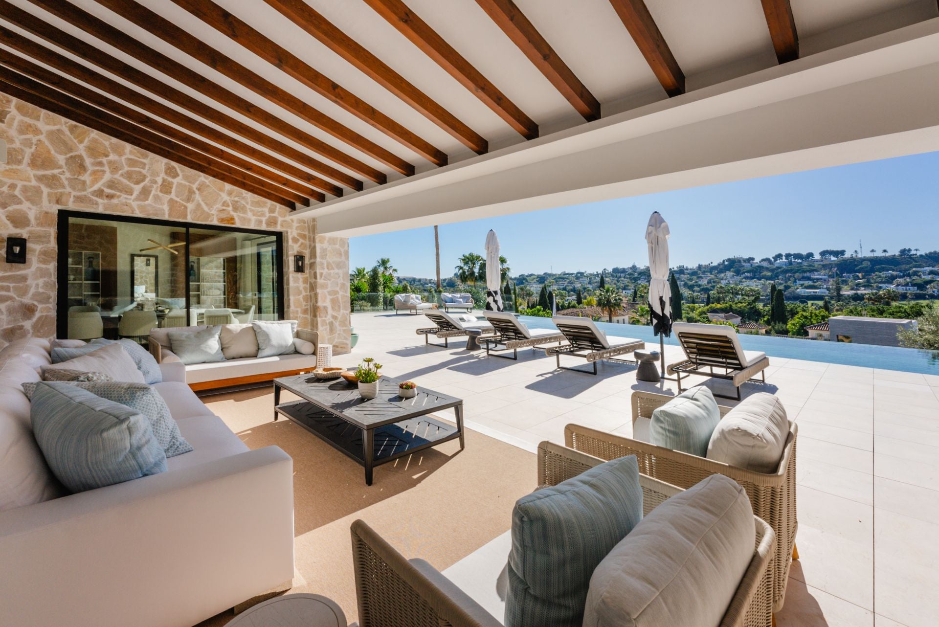 Como particularidad, esta área exterior incluye una extensa piscina que se presenta a la vista de varias estancias de la casa a través de los grandes ventanales de las mismas.