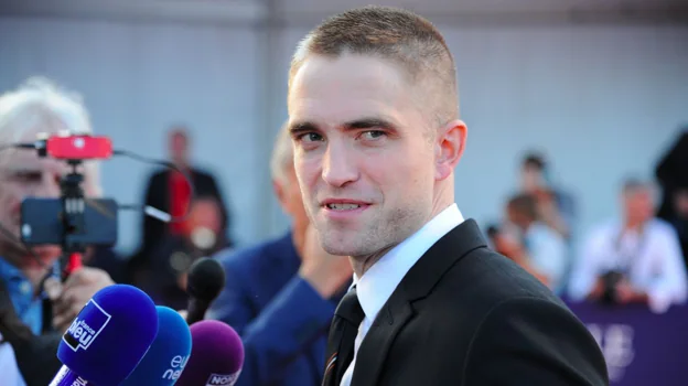 Before image - Robert Pattinson shaved and with a messy fade cut.