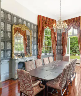 Secondary image 2 - Living room with fireplace, one of the bedrooms and the formal dining room