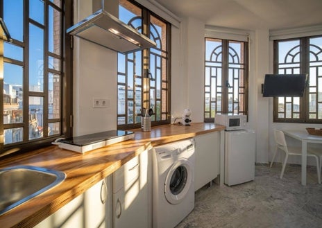 Imagen secundaria 1 - Sofá cama en el salón, con la cocina y detalle de la bañera y el dormitorio en la estancia superior