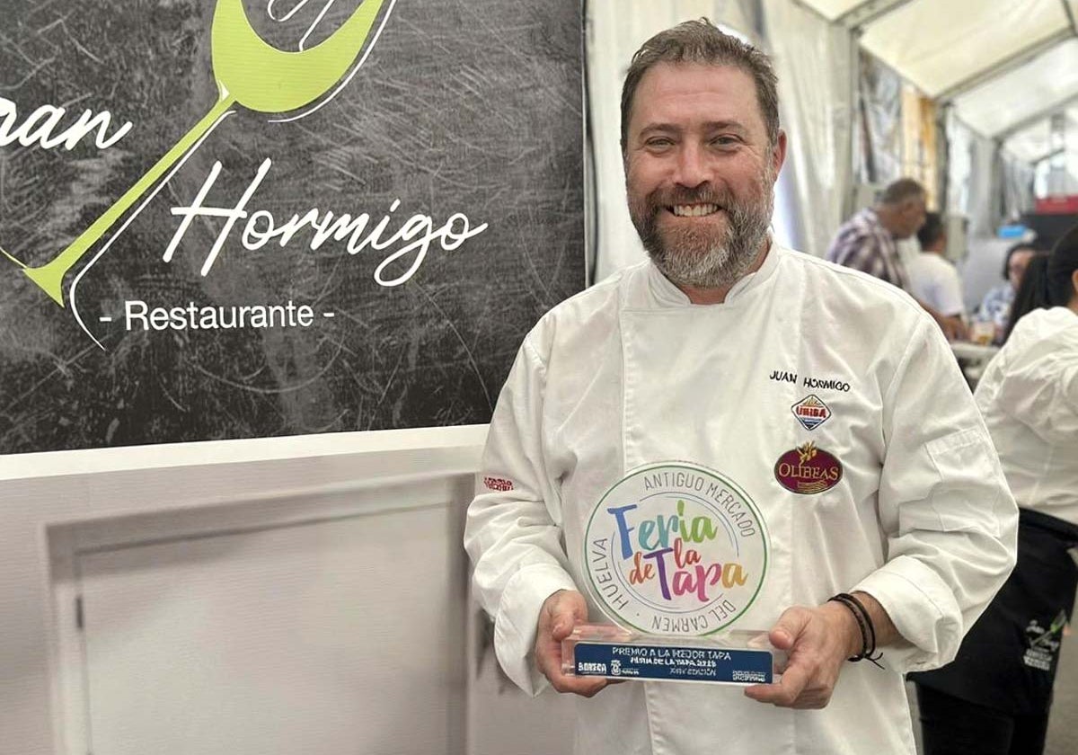 El cocinero posa orgulloso con el trofeo que le acredita como creador de la mejor tapa de la muestra