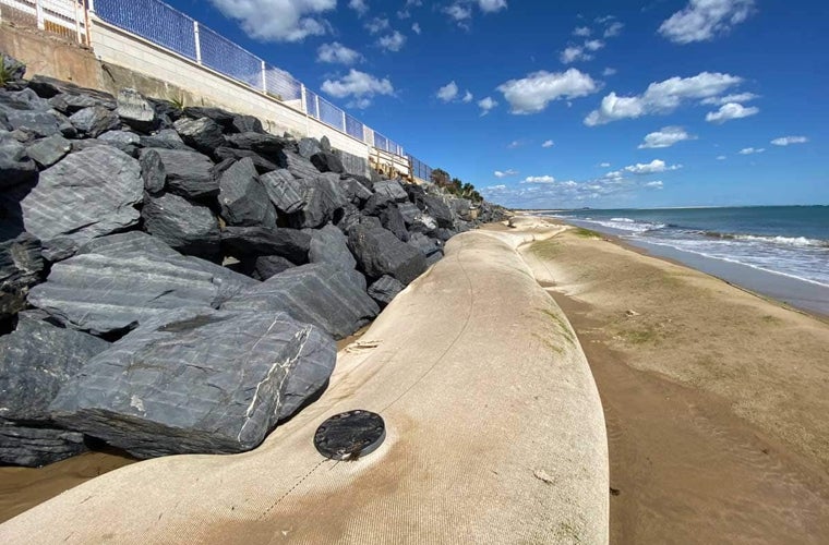 Una de las vainas de geotextil rellenas de arena colocadas en la playa de El Portil como protección