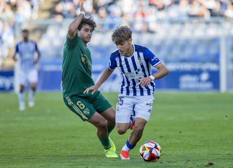 José Antonio de la Rosa presionado por un futbolista del Linares