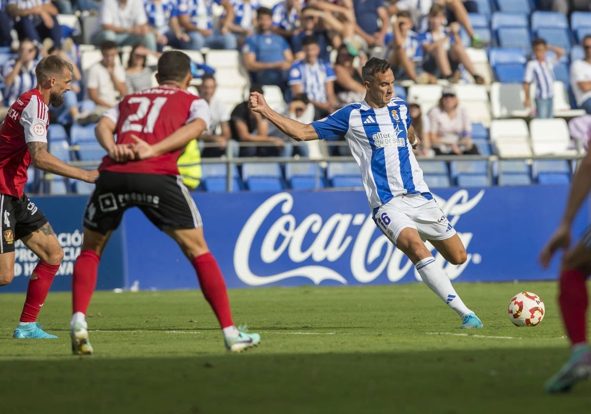 Pablo Caballero golpeando el balón durante el Recreativo-Murcia en el Nuevo Colombino