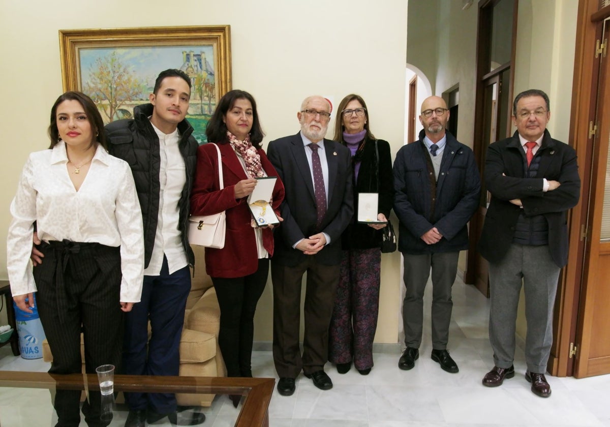 Familiares de los fallecidos, con la condecoración, junto al presidente del Colegio de Cádiz.