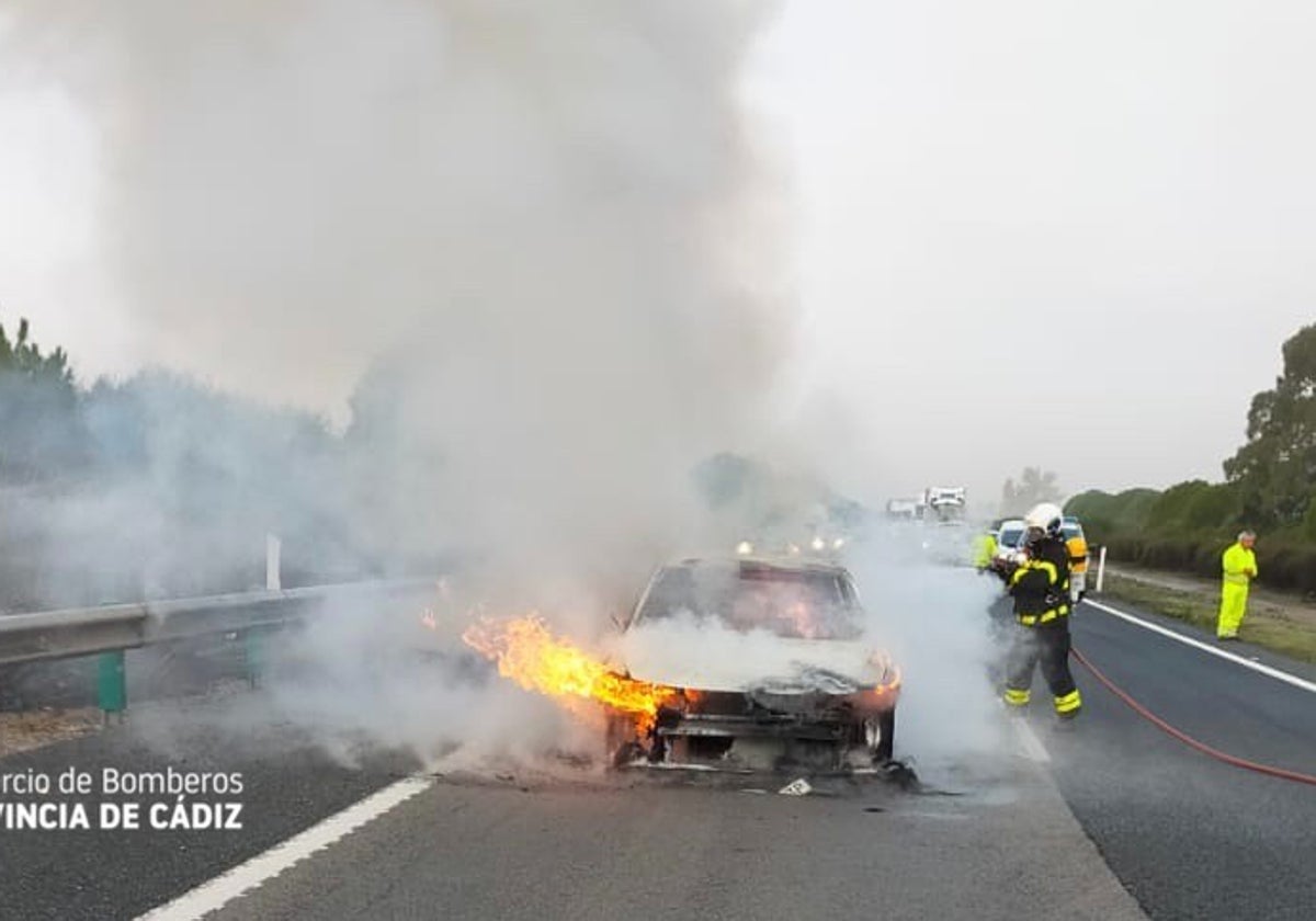 Los bomberos apagan el fuego del vehículo.